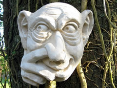 Unusual Garden sculpture of garden troll picking nose